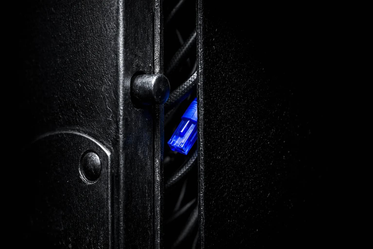 A high-security server room with a single metal door slightly ajar.